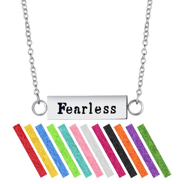 A stainless steel aromatherapy necklace diffuser with multiple colored pads, branded with 'Fearless' on the pendant, accompanied by an adjustable chain.
