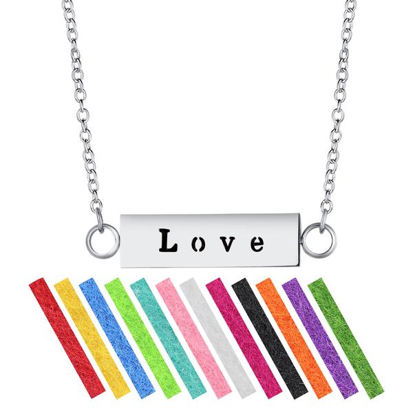 A stainless steel 'LOVE' bar aromatherapy necklace diffuser with an adjustable chain and colorful refill pads.